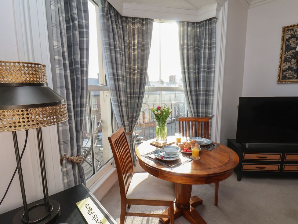 A dining area with a table and chairs at Masons Place in Whitby