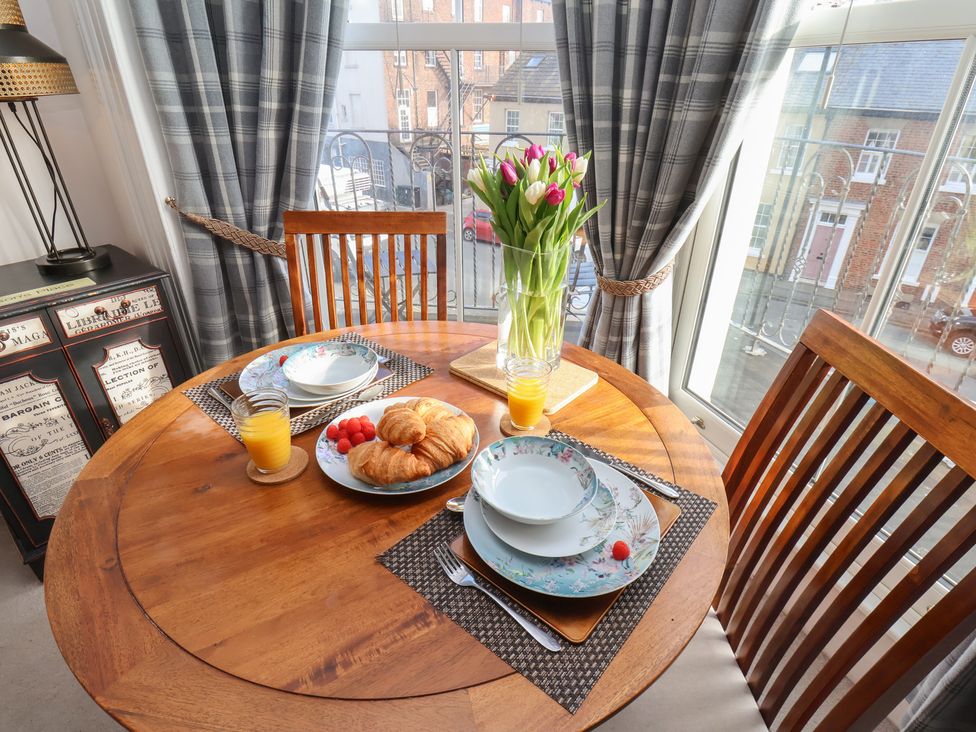 A dining room with a round table set for breakfast at Masons Place Whitby