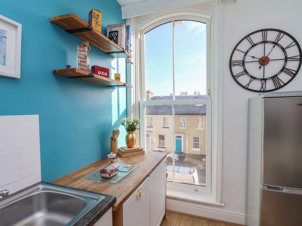 A kitchen with a sink and a shelf at Masons Place in Whitby