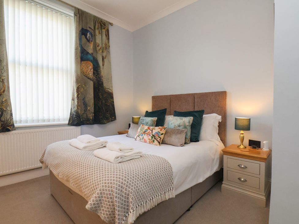 A bedroom with a bed and bedside tables at Masons Place in Whitby