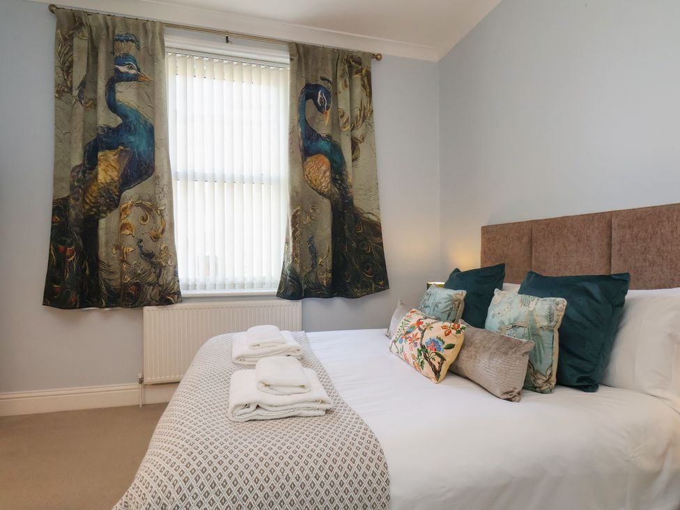 A bedroom with a bed and decorative pillows at Masons Place in Whitby