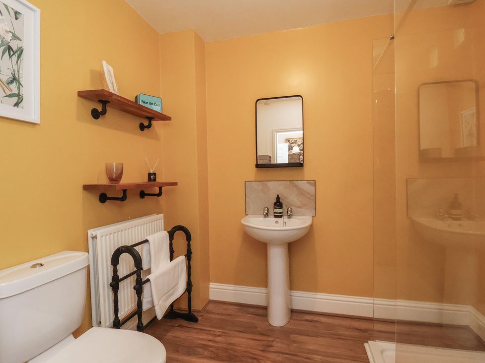 A bathroom with a sink, toilet, and shower at Masons Place in Whitby