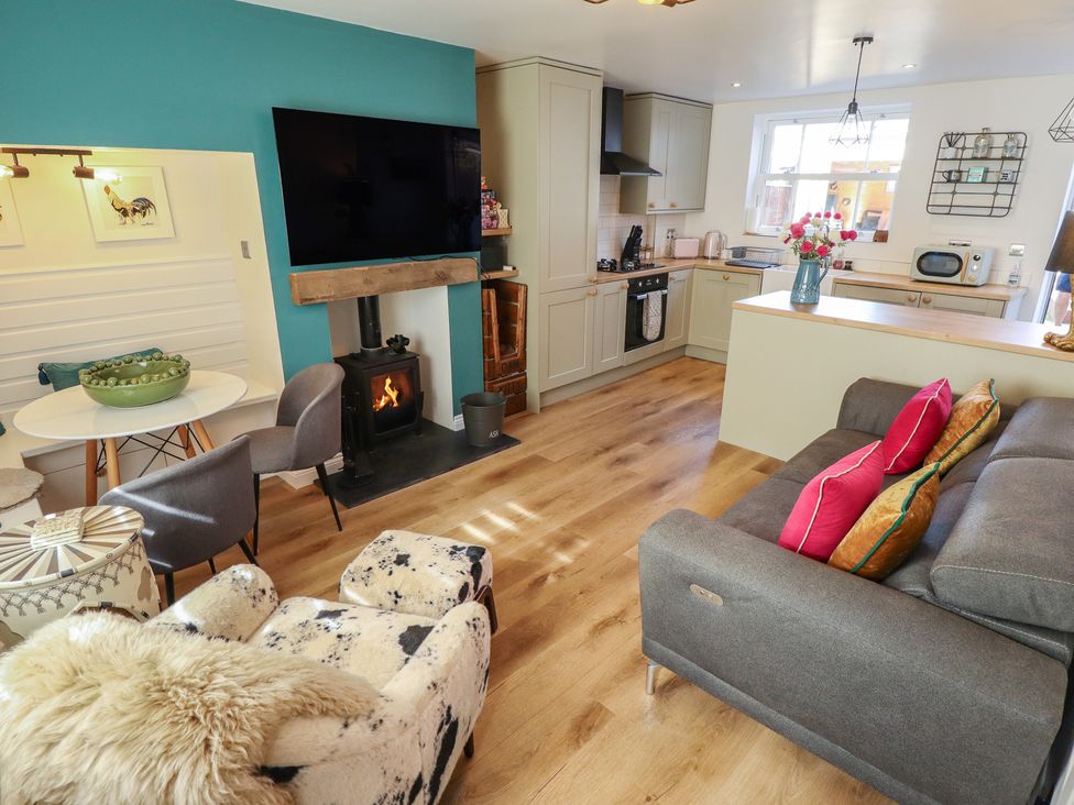 A living room with a television and kitchen area at 4 Eve Street Louth