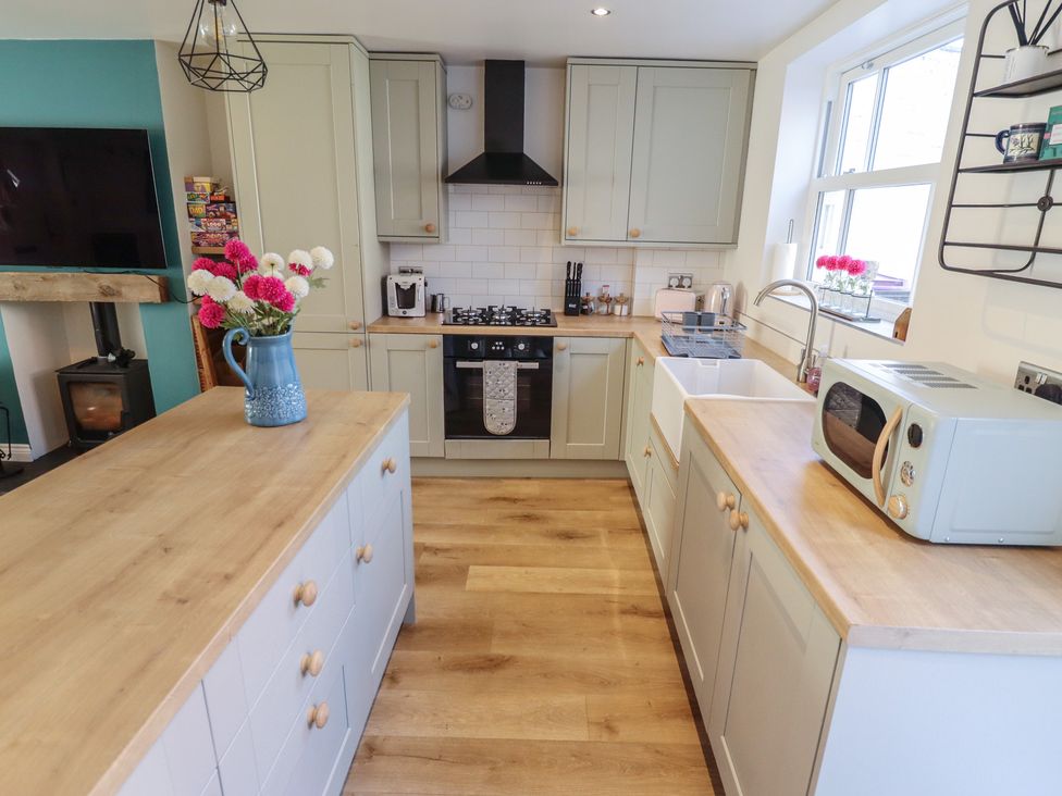 A kitchen with cabinets and appliances at 4 Eve Street in Louth