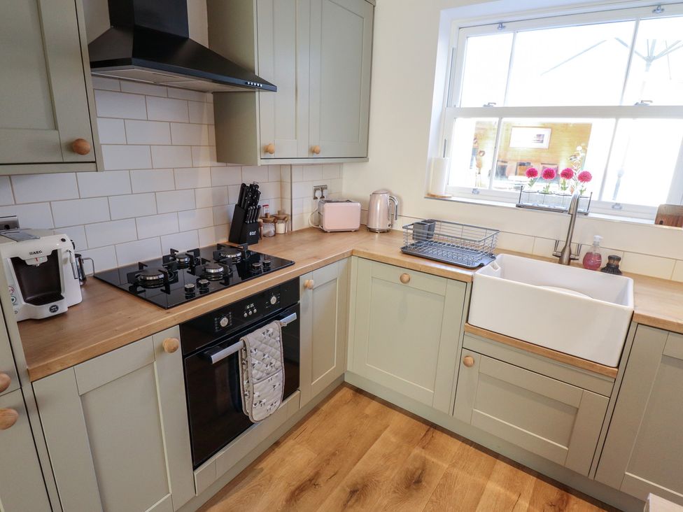 A kitchen with a stove, sink, and kitchen appliances at 4 Eve Street in Louth