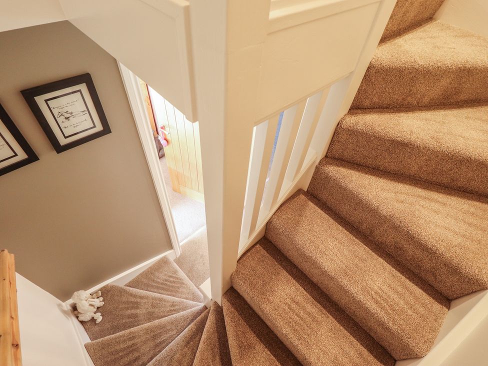 A staircase with framed pictures on the wall at 4 Eve Street in Louth