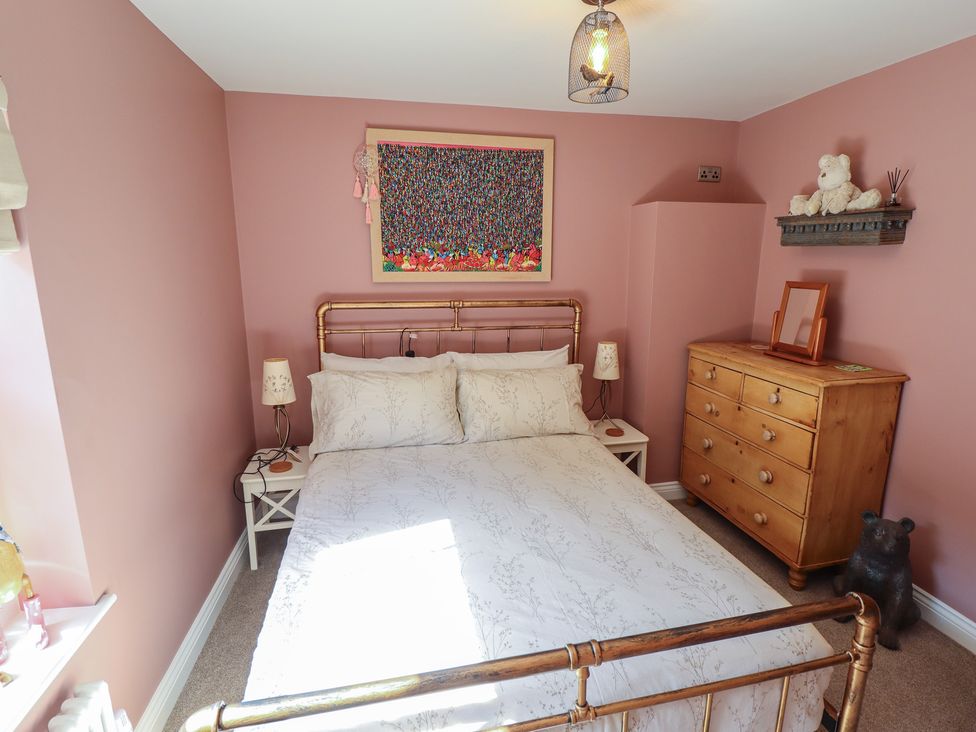 A bedroom with a bed and dressing table at 4 Eve Street in Louth