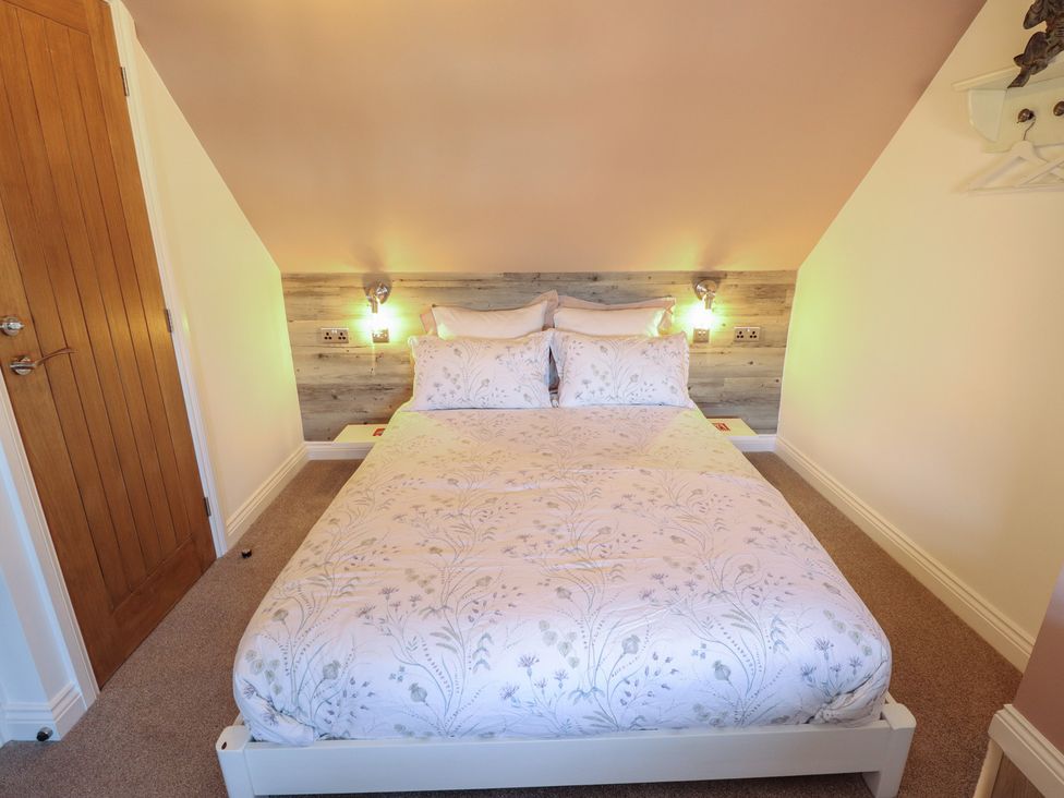 A bedroom with a bed and wooden door at 4 Eve Street in Louth