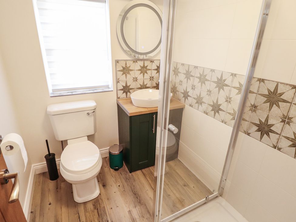 A bathroom with a toilet, sink, and shower at 4 Eve Street Louth