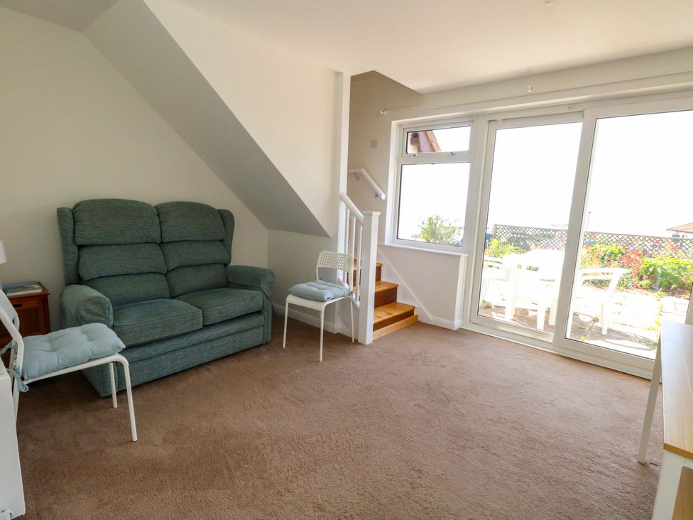A living room with a sofa and table at 32 Bowleaze Coveway in Weymouth