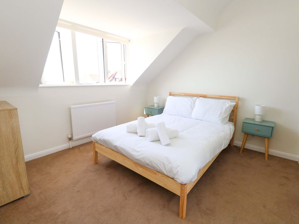 A bedroom with a bed and bedside tables at 32 Bowleaze Coveway in Weymouth