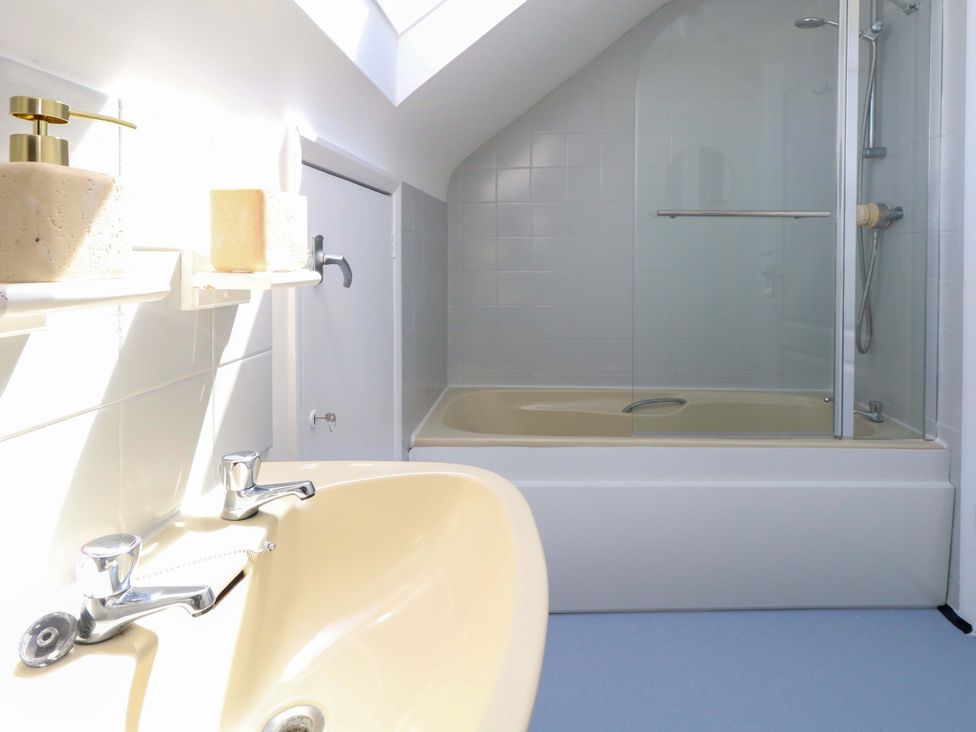 A bathroom with a sink and bathtub at 32 Bowleaze Coveway Weymouth