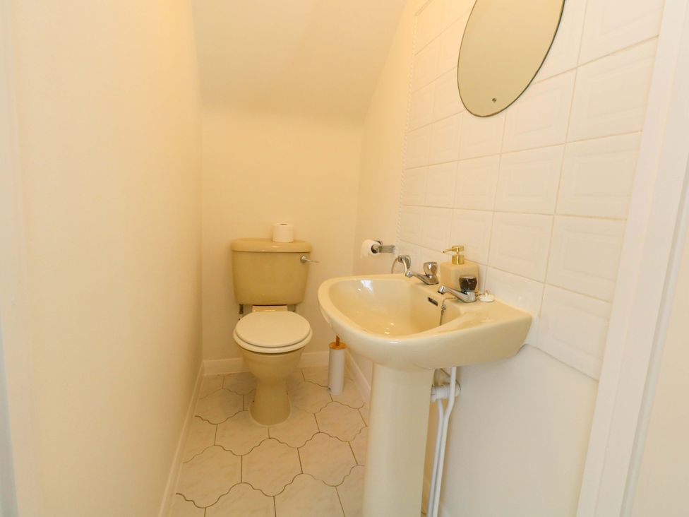 A bathroom with a toilet and sink at 32 Bowleaze Coveway in Weymouth