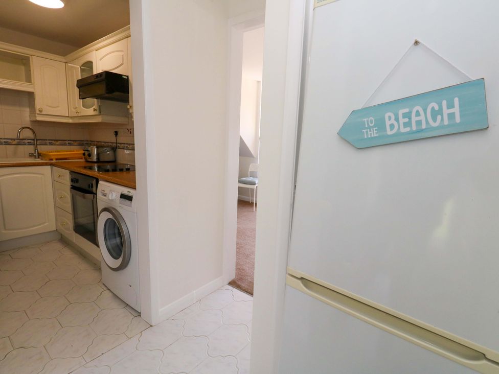 A kitchen with appliances and a sign at 32 Bowleaze Coveway Weymouth