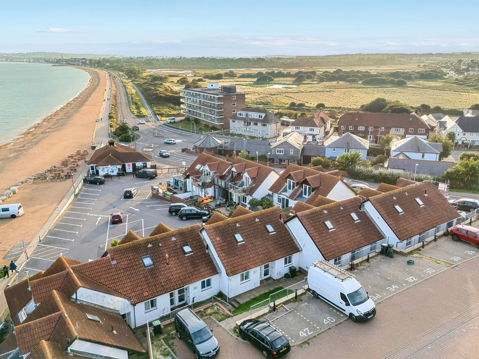 An outdoor view of houses and beach with a parking lot at 32 Bowleaze Coveway Preston
