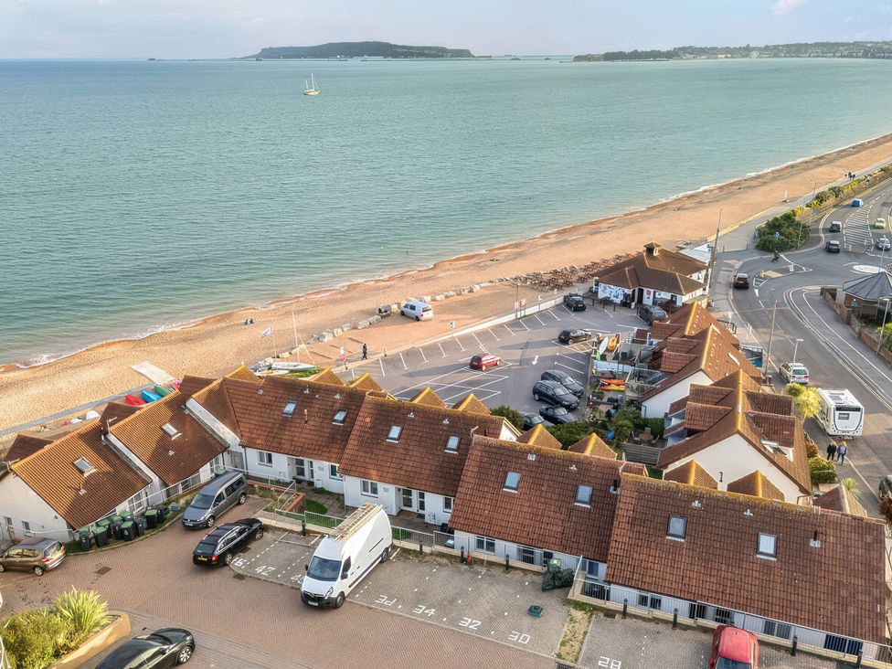 A view of the beach and sea with buildings near the shore at 32 Bowleaze Coveway Preston