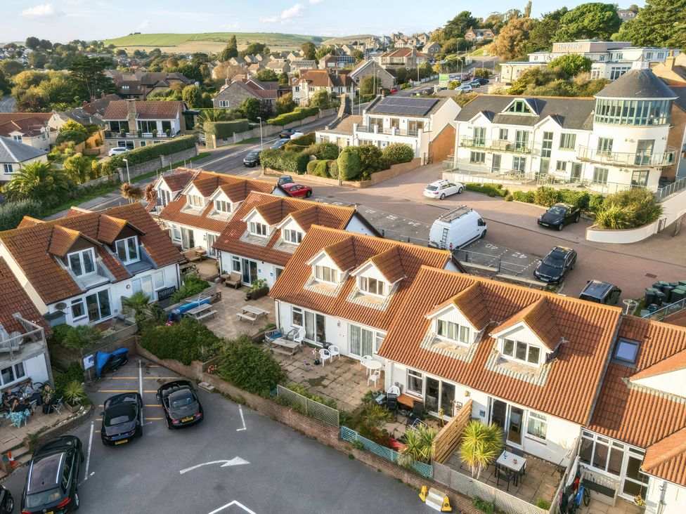 An aerial view of houses and parked cars at 32 Bowleaze Coveway in Preston