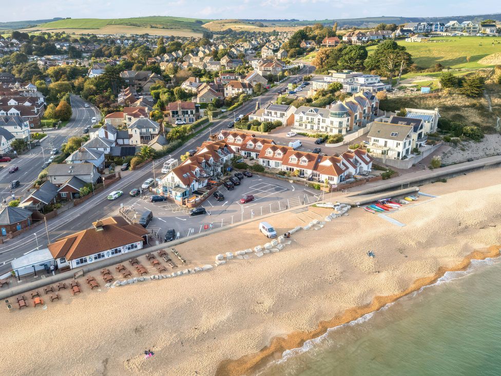An aerial view of a beach and surrounding buildings at 32 Bowleaze Coveway in Preston