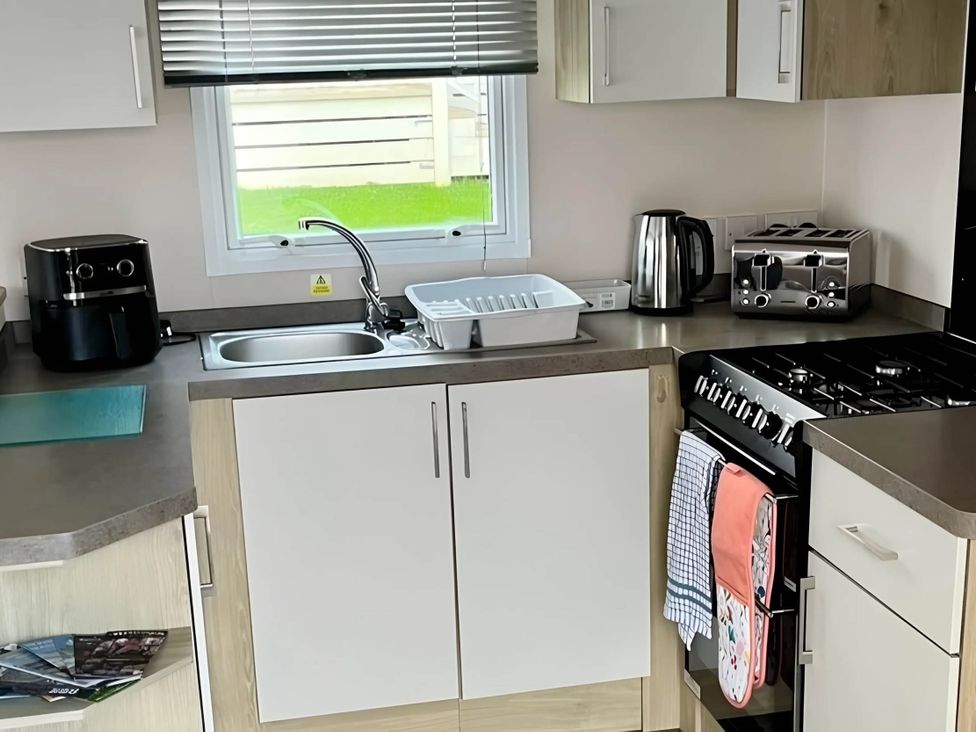A kitchen with a sink and appliances at Static Caravan Hoburne Devon Bay in Paignton