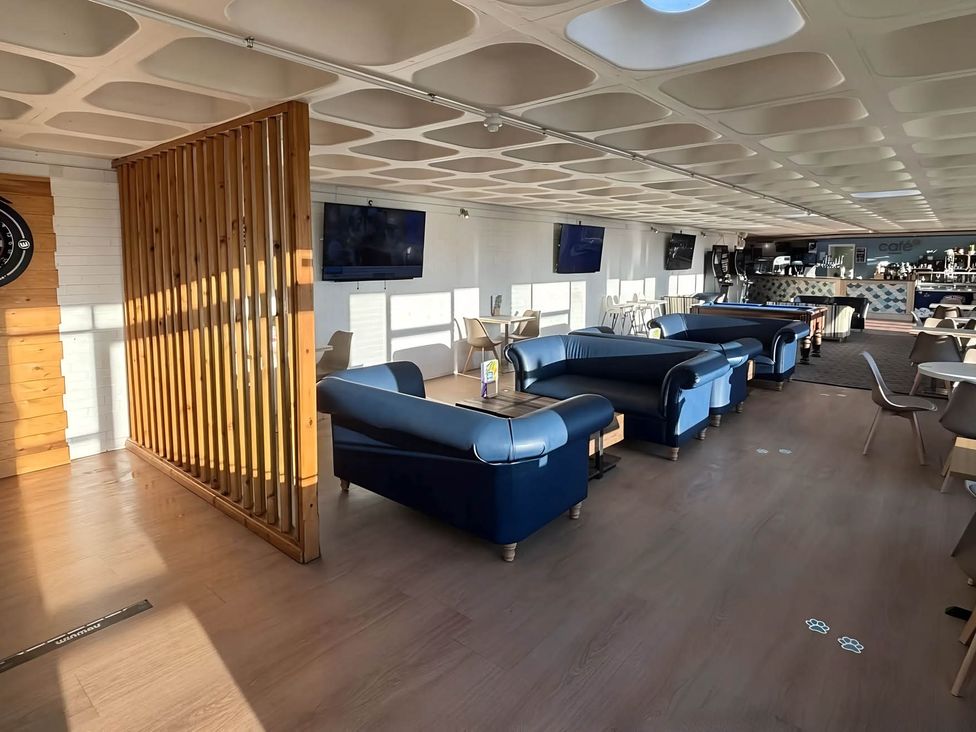 A cafe with blue sofas and tables at Static Caravan Hoburne Devon Bay, Paignton