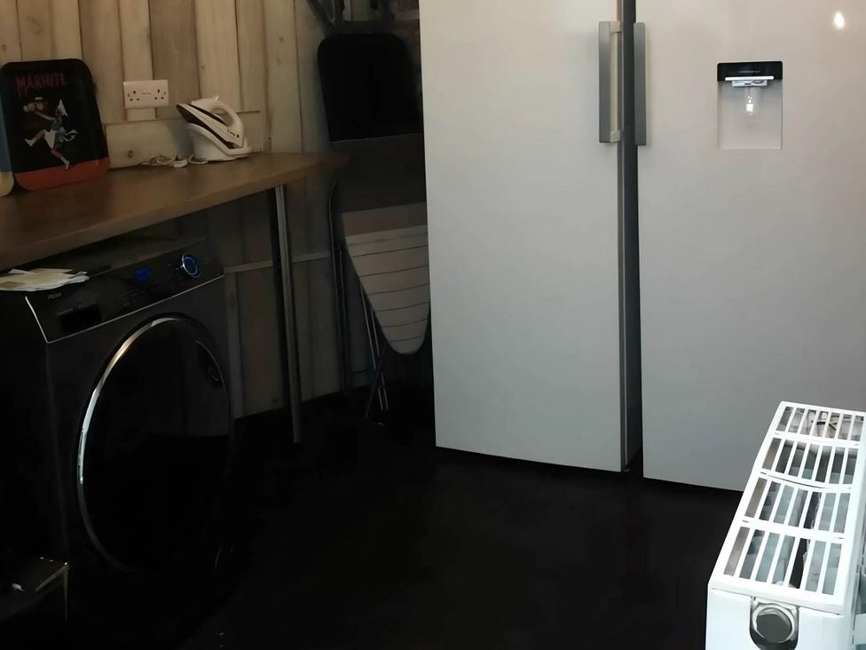 A laundry room with a washing machine and refrigerator at House - Sleeps 7 - Garden - Pets Ok - Parking in Torquay