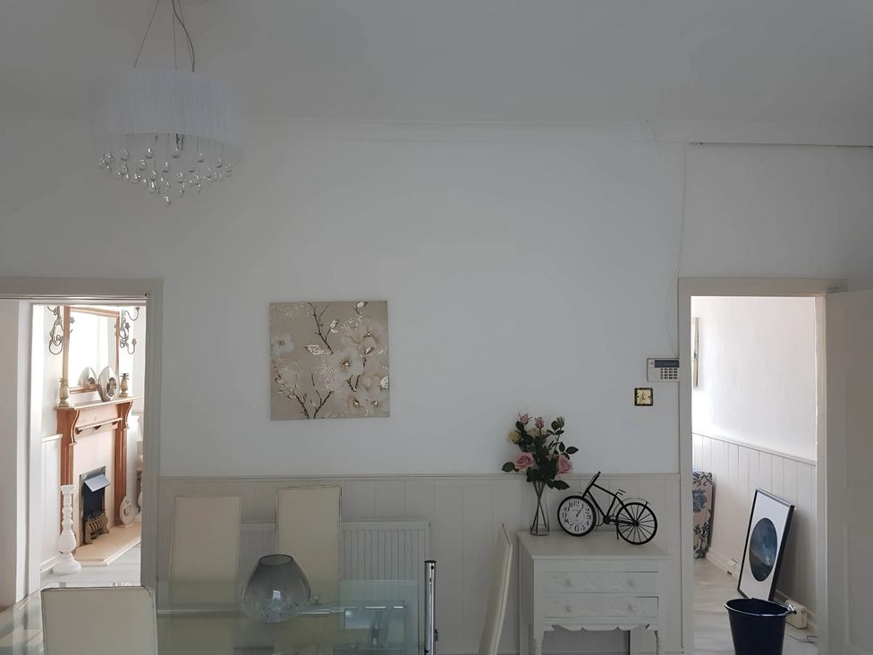 A dining room with a chandelier and a flower vase at House - Sleeps 7 - Garden - Pets Ok - Parking in Torquay