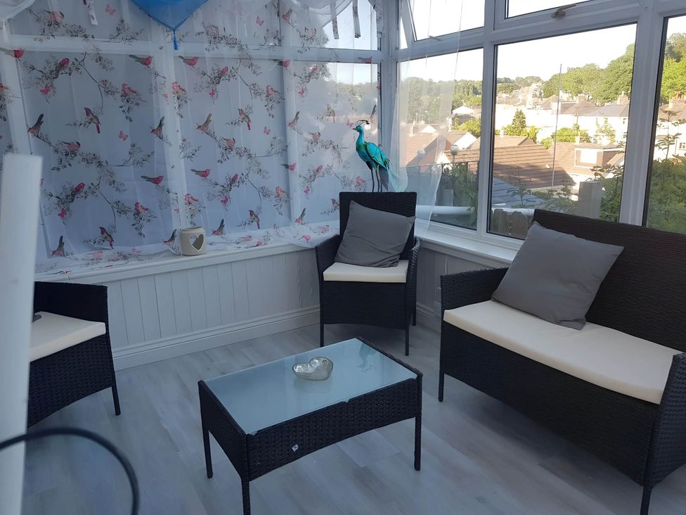 A conservatory with two sofas and a coffee table at House - Sleeps 7 - Garden - Pets Ok - Parking, Torquay