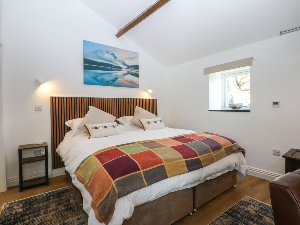 A bedroom with a bed and bedside table at Studio near Bontnewydd