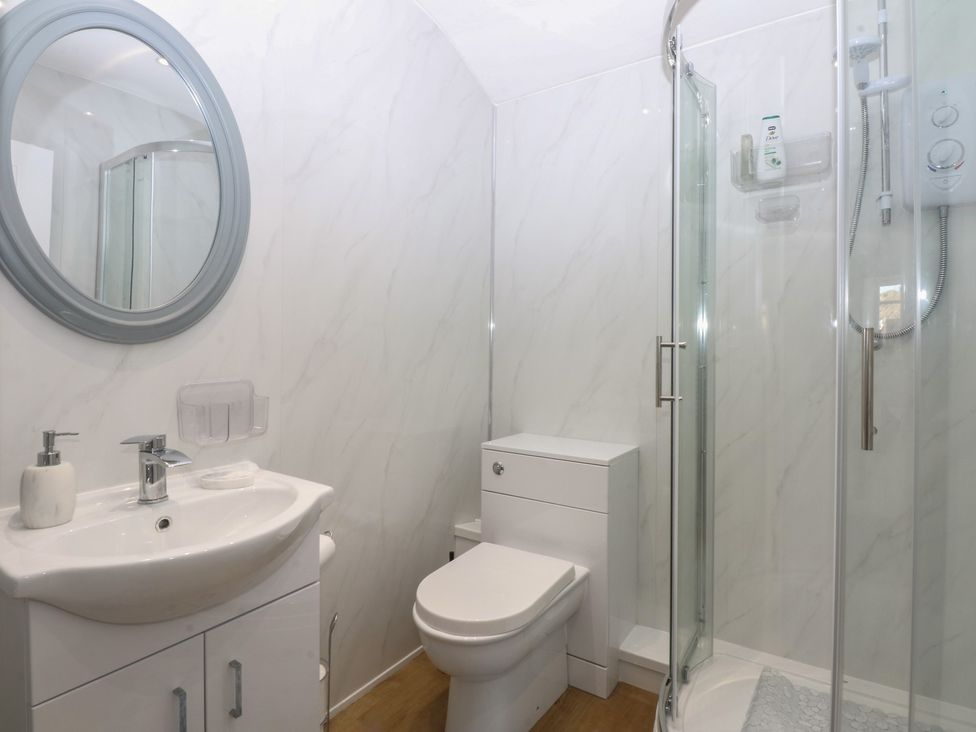 A bathroom with a shower, sink, and toilet at Studio near Bontnewydd