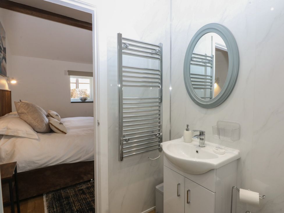 A bathroom with a sink and towel radiator at Studio near Bontnewydd