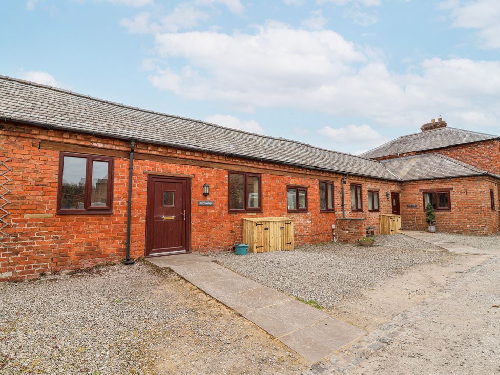 An exterior view of a brick building with a door and windows at Elwy Cottage St. Asaph