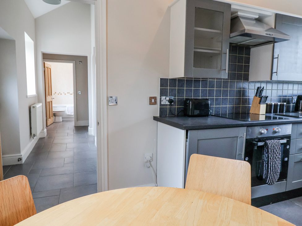 A kitchen with a table and chairs at Elwy Cottage in St. Asaph