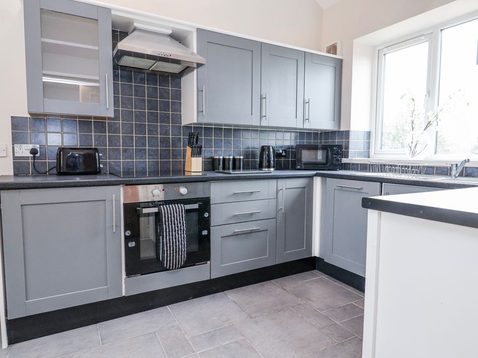 A kitchen with appliances and utensils at Elwy Cottage in St. Asaph