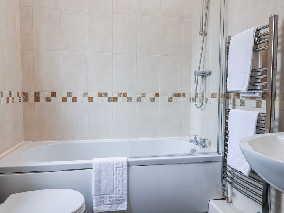 A bathroom with a bathtub and sink at Elwy Cottage in St. Asaph