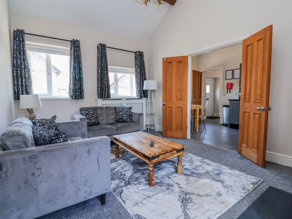 A living room with a sofa and coffee table at Elwy Cottage St Asaph