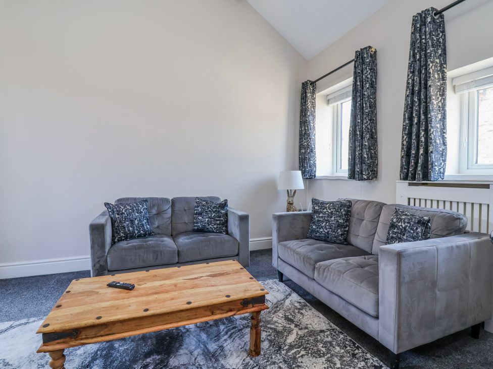 A living room with sofas and a coffee table at Elwy Cottage St Asaph