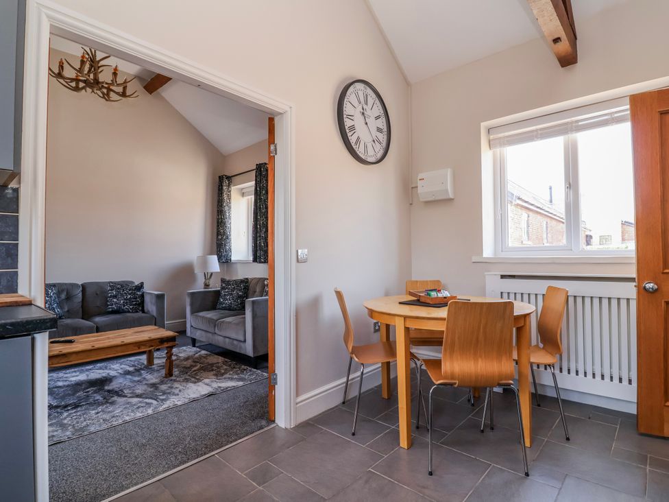 A dining room with a table and chairs at Elwy Cottage in St Asaph