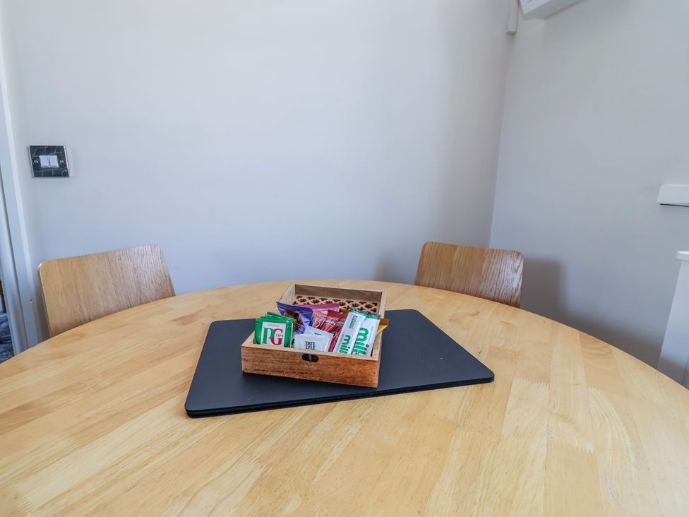 A dining room with a table and chairs at Elwy Cottage St Asaph