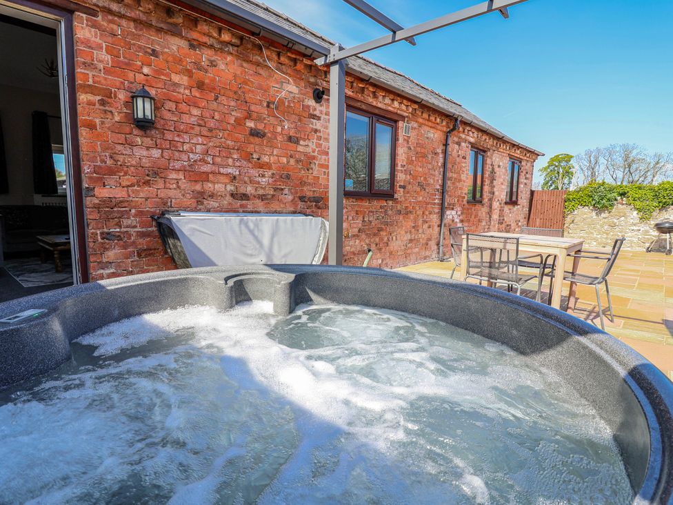A hot tub in an outdoor area at Elwy Cottage in St Asaph