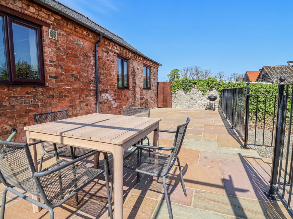 An outdoor area with a table and chairs at Elwy Cottage in St Asaph