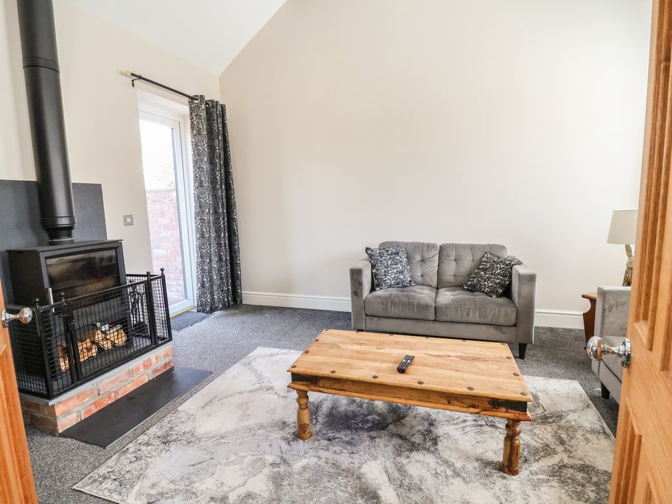 A living room with a sofa and coffee table at Elwy Cottage in St Asaph