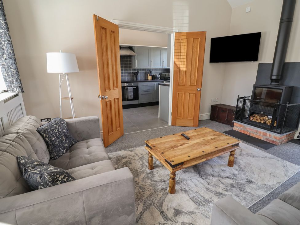 A living room with a sofa and a coffee table at Elwy Cottage St Asaph