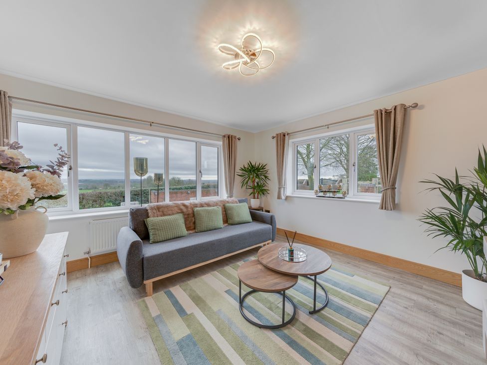 A living room with a sofa and coffee table at Greenacres Farm in Harriseahead near Mow Cop