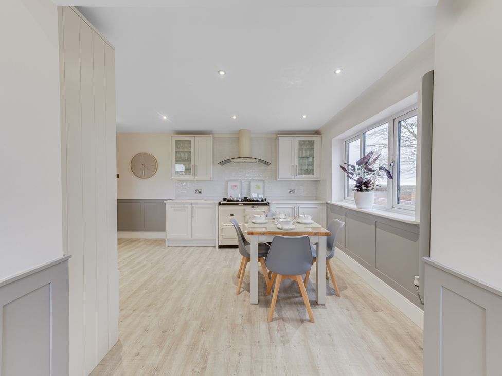 A kitchen with a table and chairs at Greenacres Farm in Harriseahead near Mow Cop