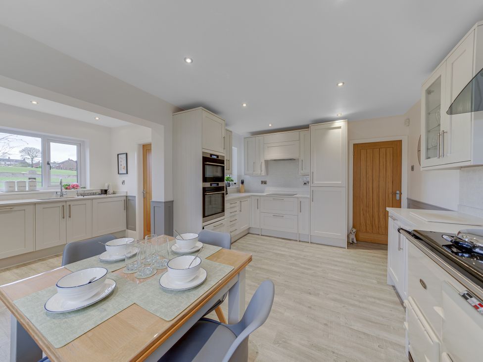 A kitchen with table set for dining at Greenacres Farm Harriseahead near Mow Cop