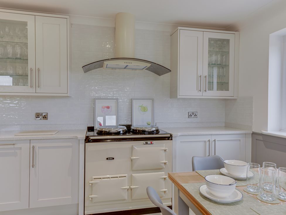A kitchen with cabinets and a stove at Greenacres Farm Harriseahead near Mow Cop