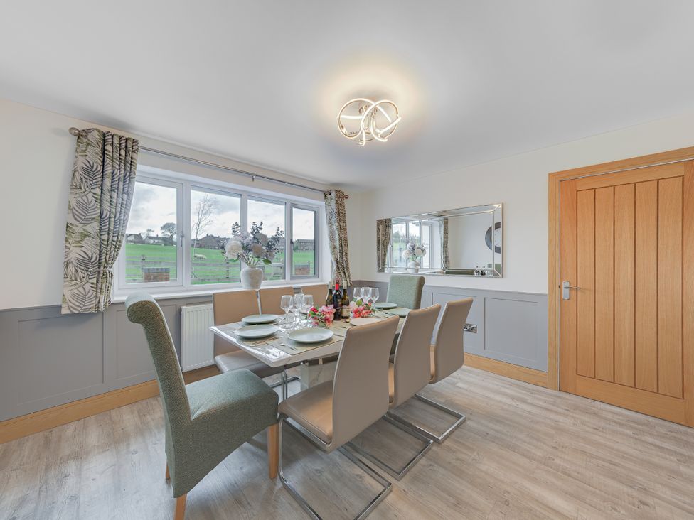 A dining room with a table set for dinner at Greenacres Farm Harriseahead near Mow Cop