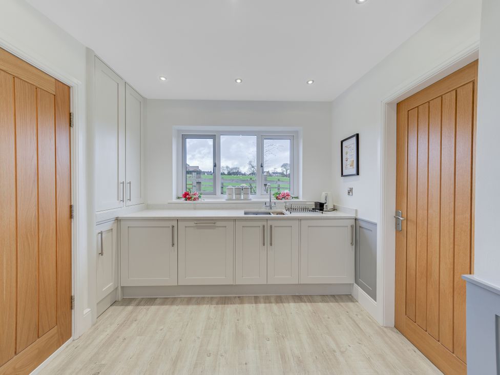 A kitchen with cabinets and a sink at Greenacres Farm Harriseahead near Mow Cop