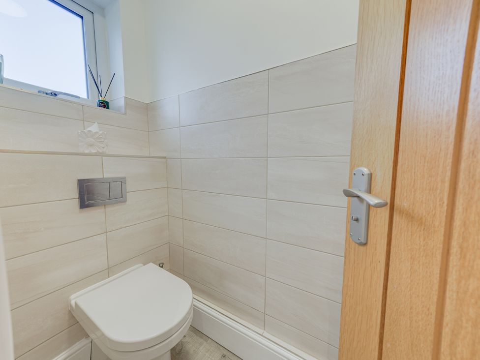 A bathroom with a toilet and window at Greenacres Farm Harriseahead near Mow Cop