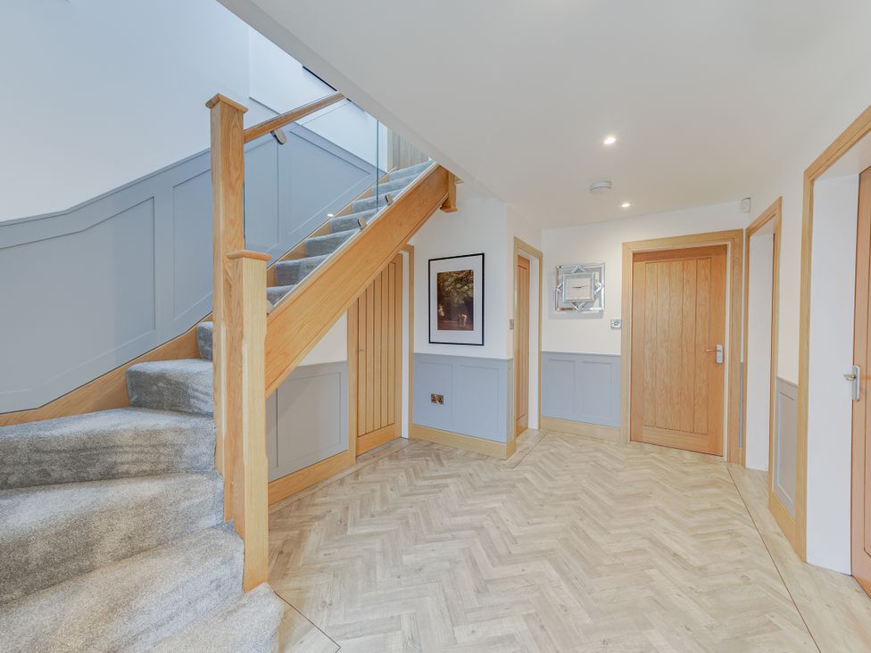 A hallway with staircase and doors at Greenacres Farm in Harriseahead near Mow Cop